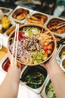 Person holding a bowl of salad photo