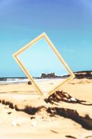 Mirror on sandy beach in summer