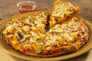 Indian style of Italian dish paneer pizza photo