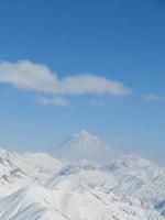 Snow-covered mountains on a clear blue day photo