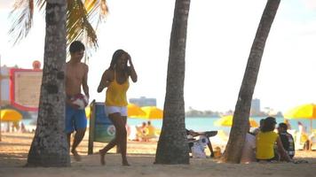 Teen boy and girl walk on beach together video