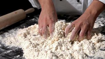 chef-kok die ingrediënten samen kneedt om een deeg te vormen video