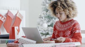 Pretty young woman buying gifts online