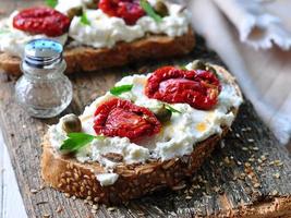 toast of rye bread with different seeds with ricotta cheese, photo