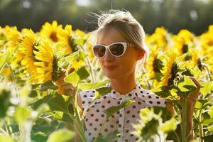 Woman clowns in the sunflowers photo