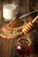 Honey with bread and milk photo