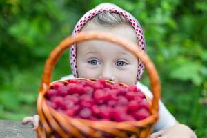 girl with a basket of raspberries photo