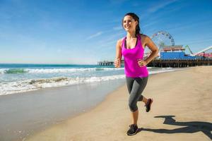 Woman fit healthy happy jogging beach space cardio weight loss photo