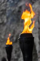 Oil flaming black metal torch. Medieval lighting equipment.