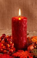 Autumn candle on a brown backdrop