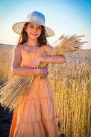 Girl on wheat field photo