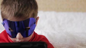 Boy superhero with tablet video