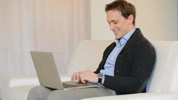 Happy man relaxing at laptop video