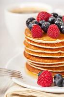 Stack of pancakes with berries breakfast photo