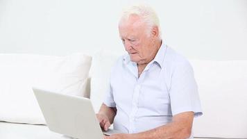 gammal man som använder en bärbar dator video