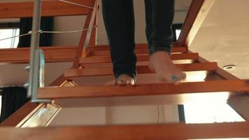 Woman hurries down the stairs to join a video call