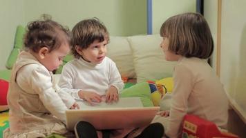Three little girls using laptop computer video