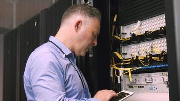 Technician using laptop to analyse server video