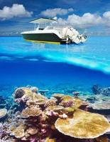 Beach and motor boat with coral reef underwater view photo