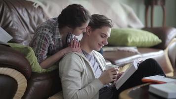 Young couple of students studying at home video