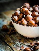 Hazelnuts on rustic wooden background