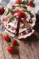 Strawberry pie close-up vertical top view of rustic style photo