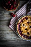 Homemade cherry pie on rustic background photo