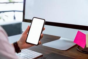 Woman holding smartphone mockup of blank screen photo