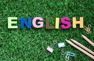 Colorful English word cubes on green grass photo
