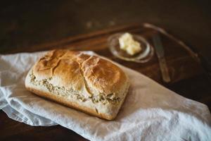 Fresh baked bread on white textile photo