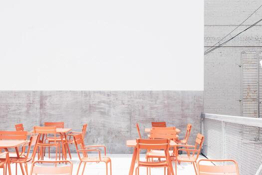 Orange table and chairs on rooftop during the day photo