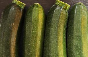 Four zucchinis for food background photo