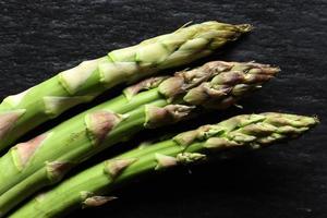 Three green asparagus stalks photo