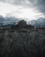 Brown barn with mountain background photo
