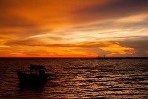 Fishing Boat on Lake at Sunset photo