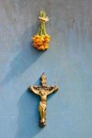 Suffering of Jesus Christ crucifixion and marigold flowers on wall