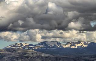 Mountain covered with snow under white and gray skies photo