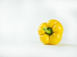 Yellow bell pepper on white background photo