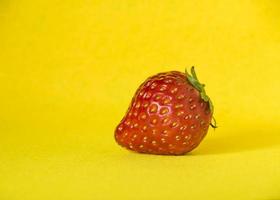 Strawberry on yellow background photo