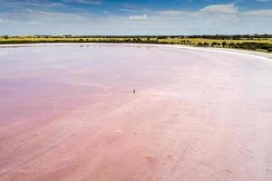 Person walking on white sand beach during daytime photo