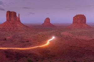 Brown rock formation with light trails