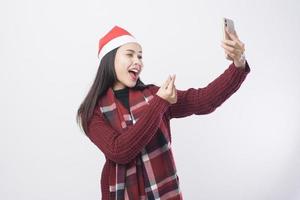 Young smiling woman wearing red Santa Claus hat