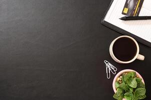 Notebook, credit card and a coffee mug on the desk photo