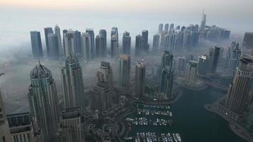 time lapse aerial view skyscraper foggy weather Dubai Marina at morning