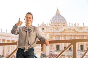 Happy young woman showing thumbs up in vatican city state photo