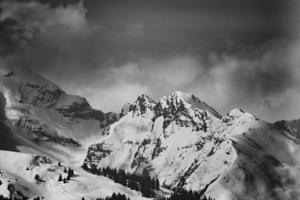 Grayscale of snowcapped mountains photo