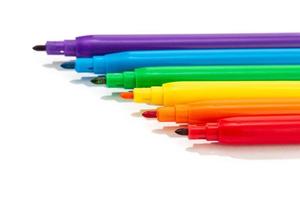 Colorful markers on a white background photo