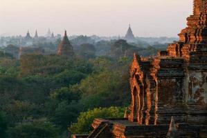 Silhouettes of ancient Buddhist Temples by sunrise at Bagan photo