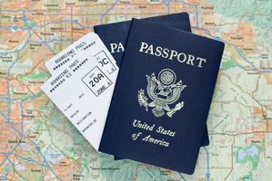 Airplane boarding passes and American passports over map photo