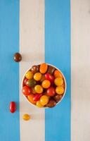 Bowl with multicolored fresh ecologic tomatoes. photo